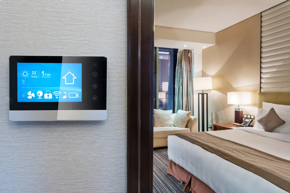 An in-wall control panel beside a hotel bedroom doorway.